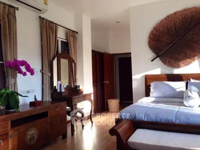 Elegant bedroom with wooden furniture and large leaf wall art