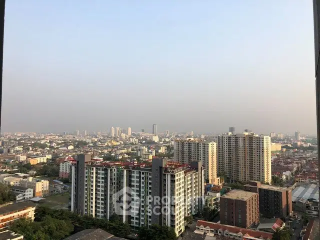 Stunning cityscape view from high-rise apartment balcony showcasing urban skyline.