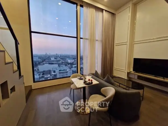 Luxurious high-rise living room with stunning city view and elegant decor.