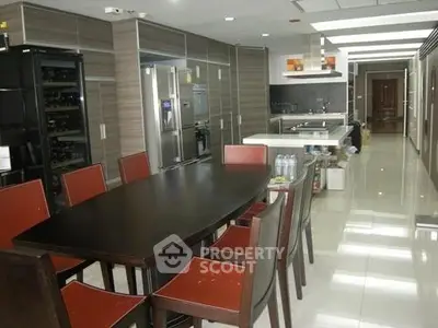 Spacious modern kitchen with sleek cabinetry and dining area