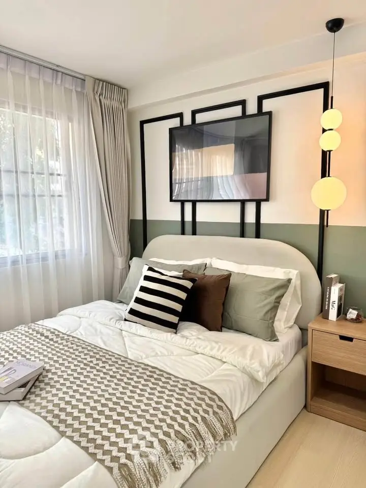 Cozy bedroom with modern decor, featuring a stylish bed, elegant lighting, and a large window for natural light.
