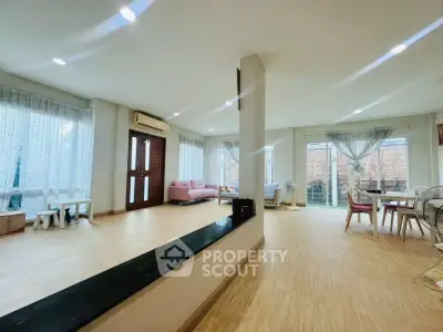 Spacious open-plan living room with modern decor and natural light