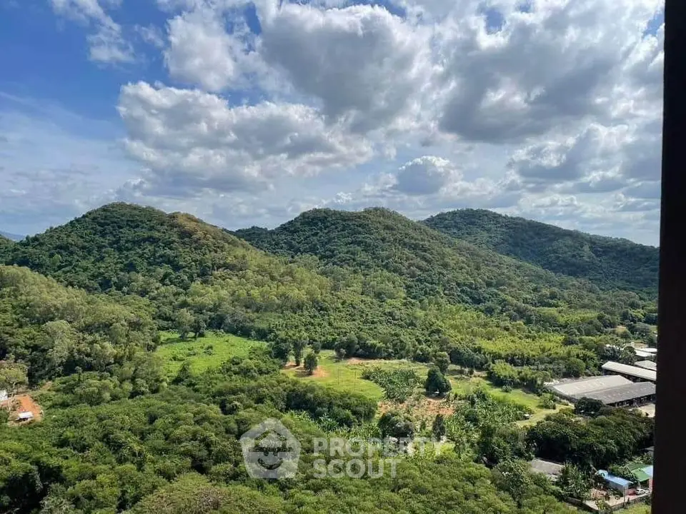 Stunning panoramic view of lush green hills under a vibrant blue sky, perfect for nature lovers.