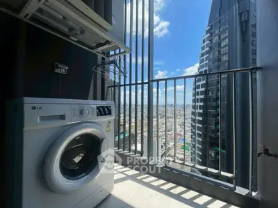 Modern balcony with washing machine and stunning city view in high-rise building.