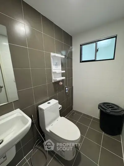 Modern bathroom with sleek tiles and compact fixtures