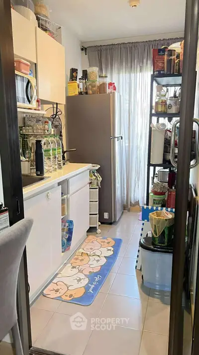 Cozy kitchen with modern appliances and ample storage space, perfect for culinary enthusiasts.