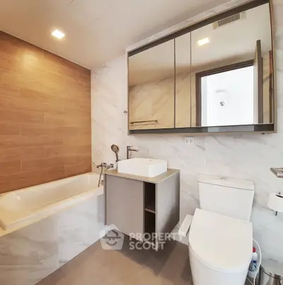 Modern bathroom with elegant fixtures and stylish wood accent wall