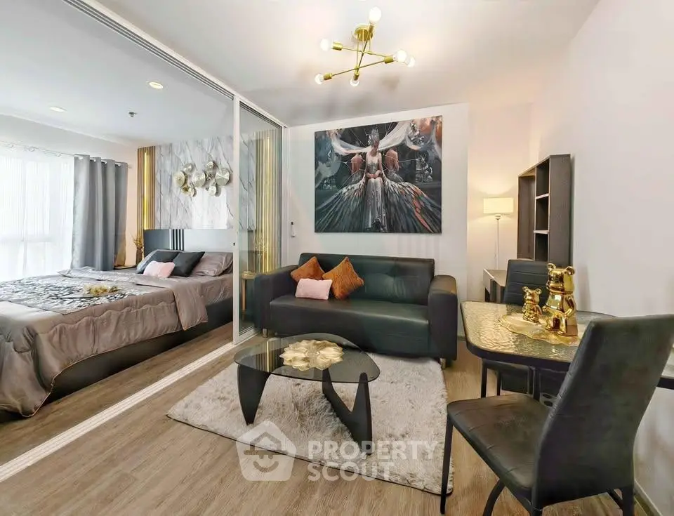 Modern apartment interior with stylish living room and cozy bedroom separated by glass partition.