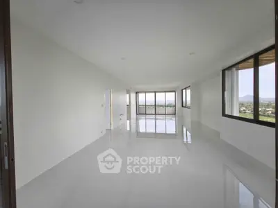 Spacious modern living room with large windows and stunning mountain views