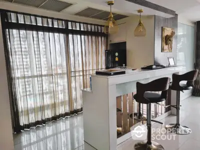 Modern kitchen with sleek bar counter and stylish stools in a high-rise apartment