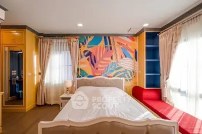 Vibrant bedroom with colorful mural and elegant furnishings, perfect for modern living.