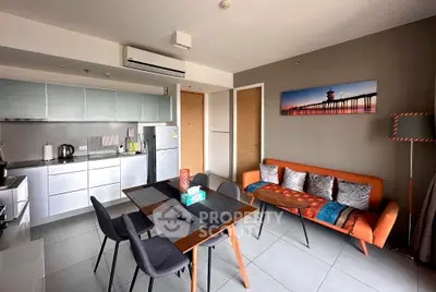 Modern living room with stylish furniture and open kitchen layout in a contemporary apartment.