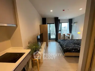 Modern studio apartment with open layout and city view balcony