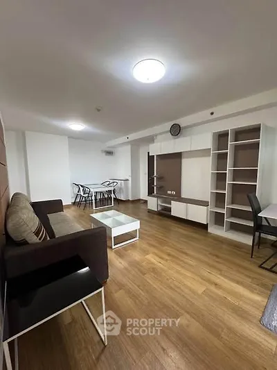 Spacious modern living room with stylish furniture and wooden flooring