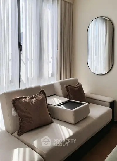 Modern living room with elegant sofa and stylish mirror