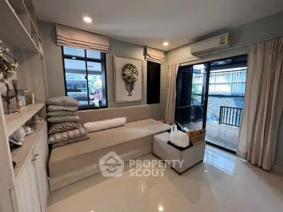Cozy living room with modern decor and large windows for natural light.