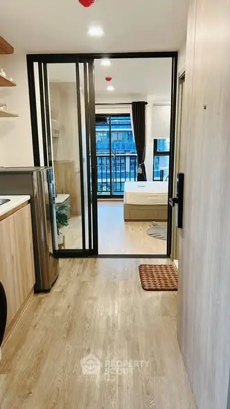 Modern studio apartment with open layout and balcony view