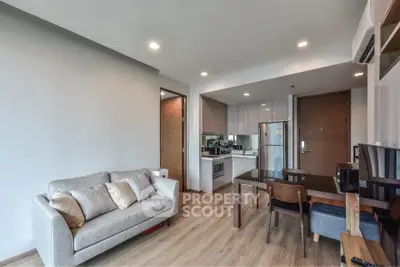 Modern living room with open kitchen and stylish furniture in a cozy apartment.