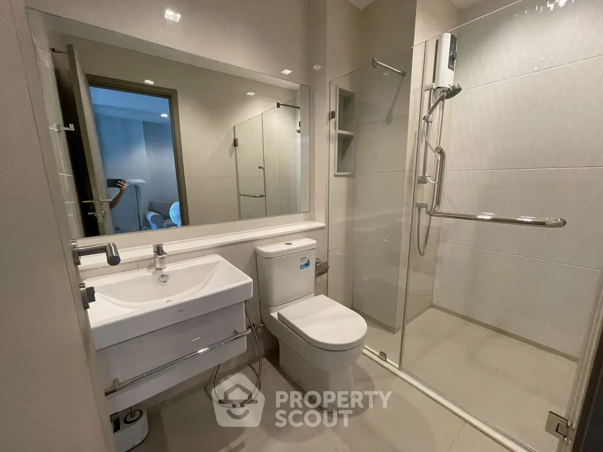 Modern bathroom with glass shower and sleek fixtures