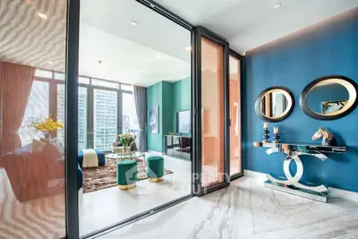 Luxurious modern living room with floor-to-ceiling windows and elegant decor in a high-rise apartment.