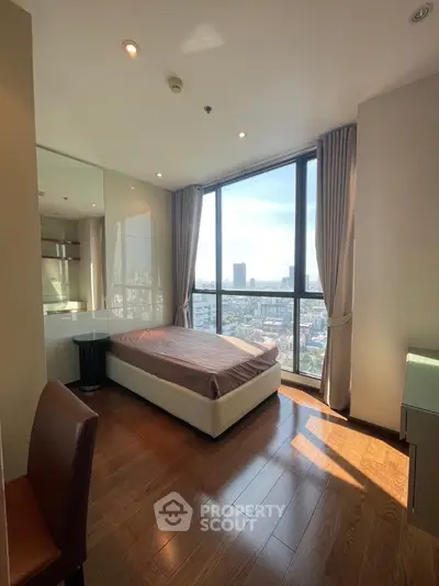 Modern bedroom with panoramic city view and elegant wooden flooring