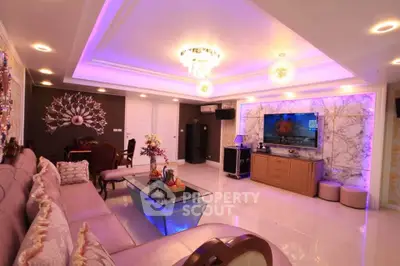 Luxurious living room with elegant lighting and modern decor, featuring a spacious seating area and entertainment setup.