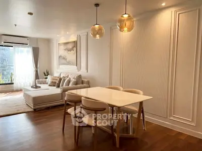 Elegant living room with modern dining area and stylish lighting