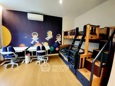 Charming kids' bedroom with space-themed decor and bunk beds