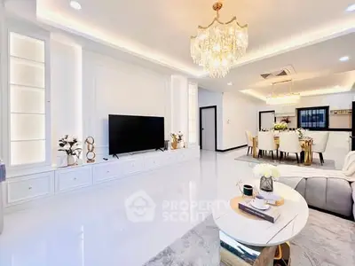 Luxurious open-plan living room with elegant chandelier and modern decor