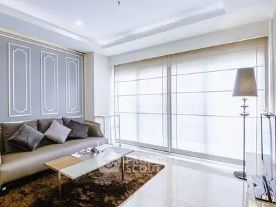 Elegant living room with modern decor and large windows for natural light.