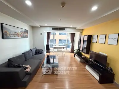 Spacious modern living room with stylish decor and large windows for natural light.