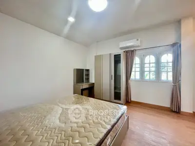 Spacious bedroom with natural light and modern furnishings