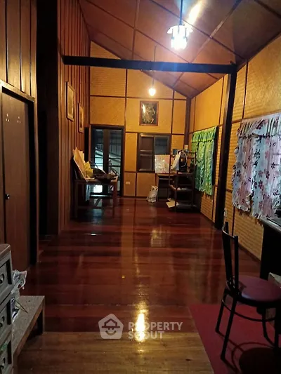 Charming rustic interior with wooden walls and floors, cozy lighting, and traditional decor.