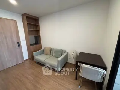 Cozy living room with modern sofa and wooden flooring in a stylish apartment.