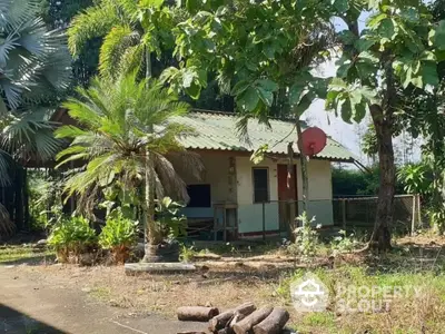 Charming rustic house surrounded by lush greenery and mature trees, perfect for nature lovers.