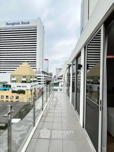 Modern balcony with city view and glass railing in urban setting