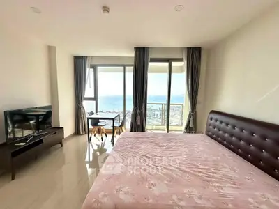 Spacious bedroom with ocean view and modern furnishings