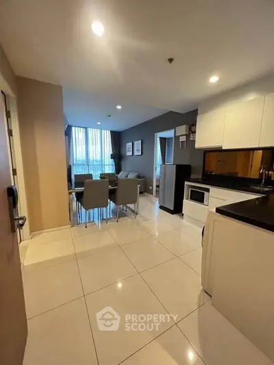 Modern open-layout kitchen and dining area with sleek appliances and stylish decor.