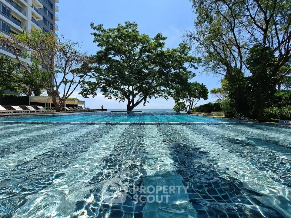 Luxurious infinity pool with stunning ocean view and lush greenery, perfect for relaxation and leisure.