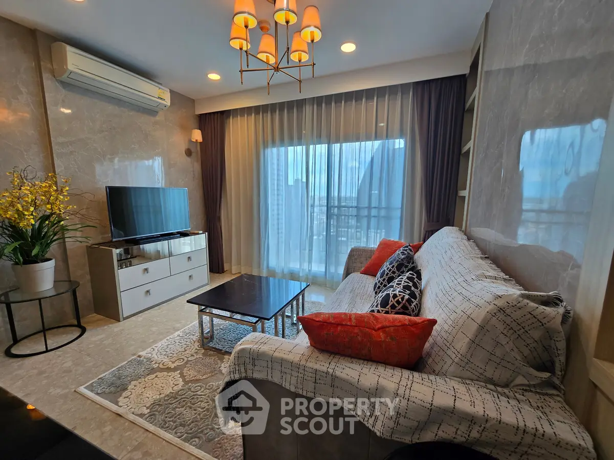 Luxurious living room with modern decor, large window, and elegant lighting in a high-rise apartment.