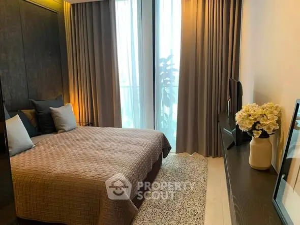 Luxurious bedroom with elegant decor and large window for natural light.