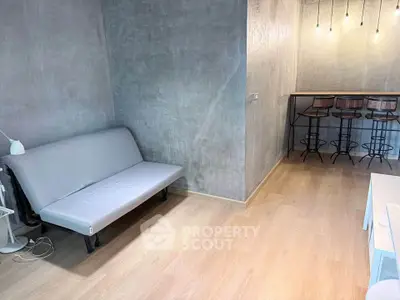 Modern minimalist living room with sleek gray walls and stylish bar seating area.