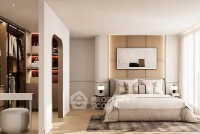 Luxurious bedroom with elegant decor and walk-in closet, featuring modern lighting and stylish furnishings.
