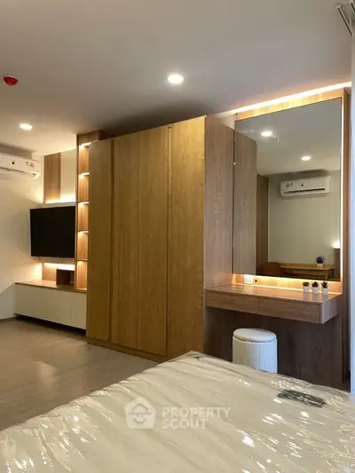 Modern bedroom with built-in wardrobe and stylish vanity area