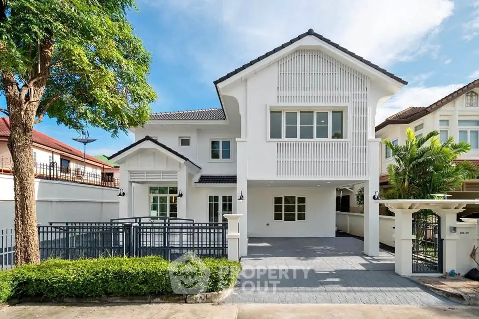 Stunning modern two-story house with spacious driveway and lush greenery, perfect for family living.