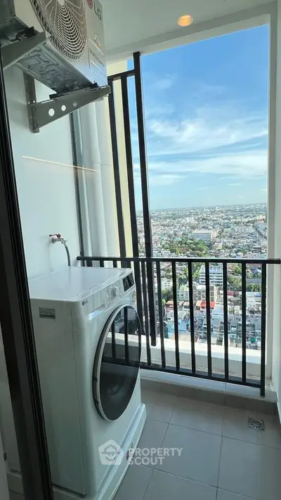 High-rise apartment balcony with washing machine and stunning city view