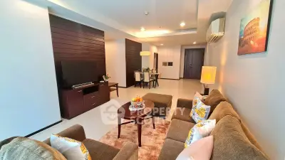 Spacious living room with modern decor and cozy seating area in a stylish apartment.