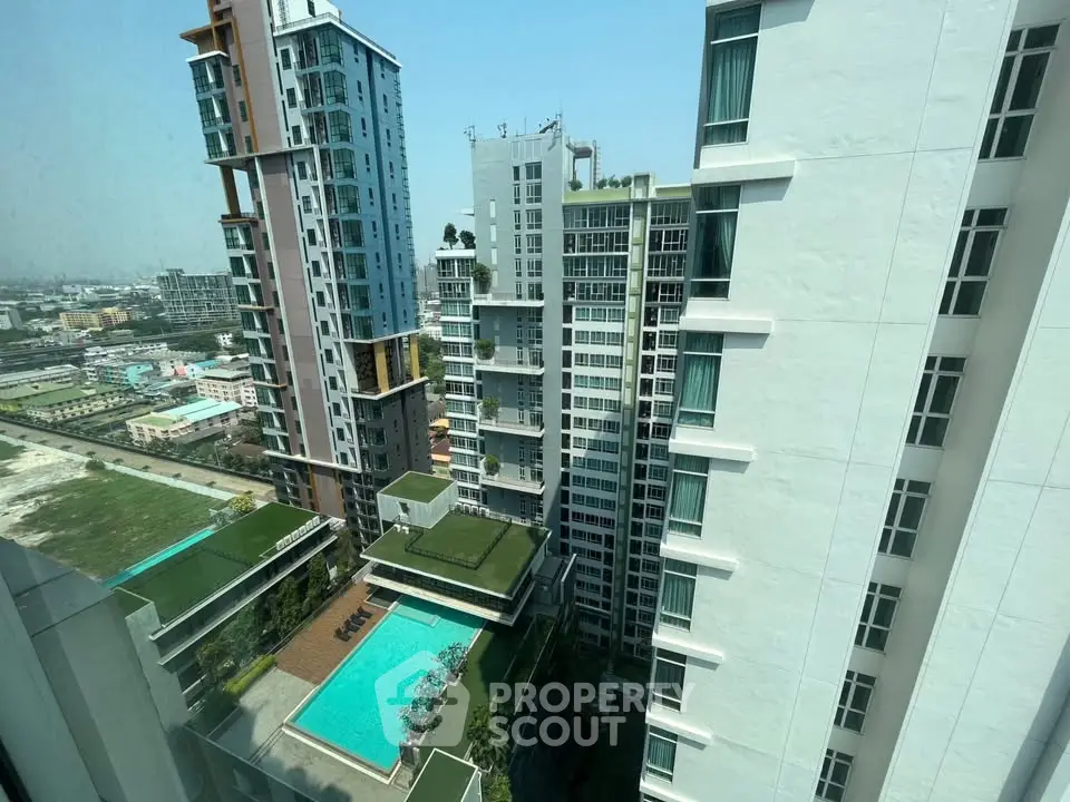 Stunning high-rise apartment view with pool and cityscape, perfect for urban living.