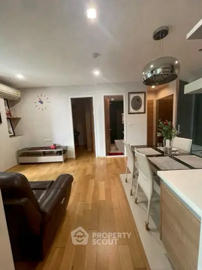 Modern living room with wooden flooring and stylish dining area