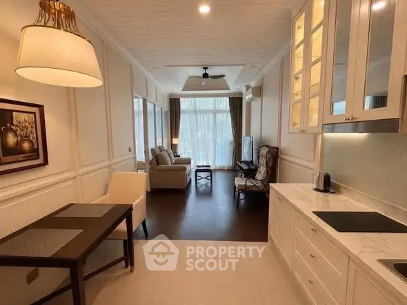 Elegant open-layout living room with modern kitchen and cozy seating area, perfect for stylish urban living.